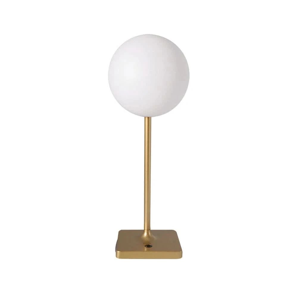 Table lamp with white spherical shade and gold base on a white background