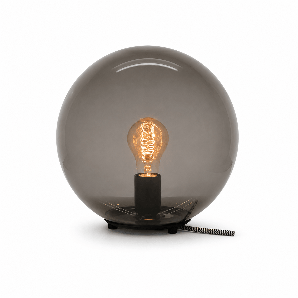 Close-up of the Global Table Lamp featuring a round opal shade and visible filament bulb.