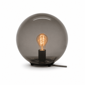 Close-up of the Global Table Lamp featuring a round opal shade and visible filament bulb.
