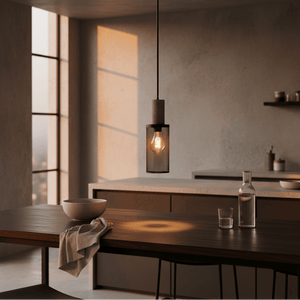 Midnight Long Mesh & Stone Pendant Light hanging over a wooden dining table, casting a warm glow.