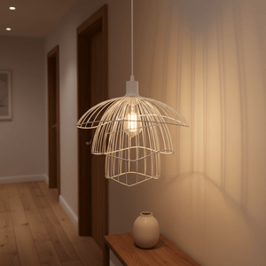 Stylish white pendant light hanging above a wooden table, casting soft shadows on the wall.