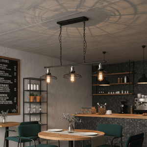 3-light black and chrome grid pendant light hanging over a wooden dining table in a modern café setting.