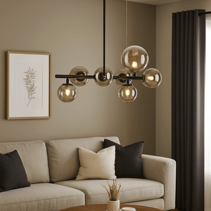 Modern chandelier hanging above a living room with a beige sofa and decorative items.