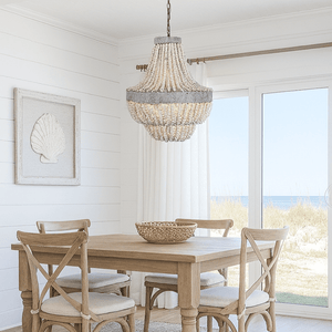 Dining room with wooden table and chairs, chandelier, and large windows.