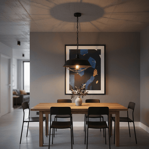 Black grid pendant light hanging above a wooden dining table with black chairs and artwork on the wall.