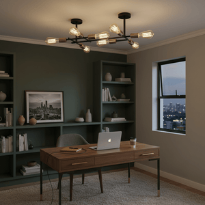 Stylish black and satin brass ceiling light fitting illuminating a modern office space with a wooden desk.