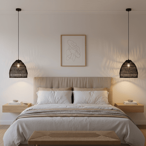 Black rattan pendant light hanging above a cozy bed in a modern bedroom setting.