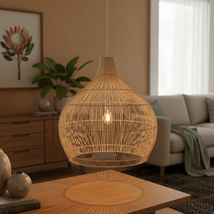 Woven bamboo and rattan pendant light casting a warm glow over a wooden table in a cozy living space.