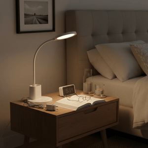 Dimmable rechargeable LED desk lamp on a bedside table, illuminating an open book and glasses.