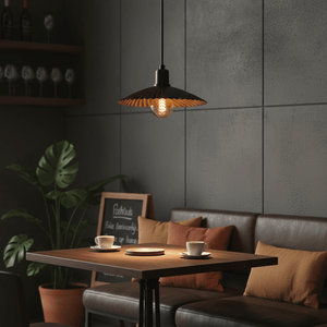 Golden Shell Pendant light hanging above a cozy dining table with cups and cushions, enhancing the modern decor.
