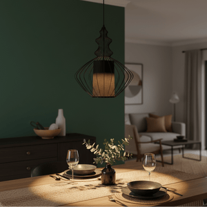 Tokyo 2 Black Wire Frame Pendant hanging over a dining table set with plates and glasses, against a green wall.