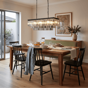 Smoke Crystal Rectangular Chandelier hanging above a wooden dining table set with plates and glasses.