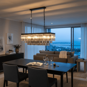 Smoke Crystal Rectangular Chandelier hanging over a dining table in a modern setting, with a view of the ocean.