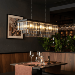 Smoke Crystal Rectangular Chandelier hanging above a dining table set with glasses and cutlery in a stylish restaurant.