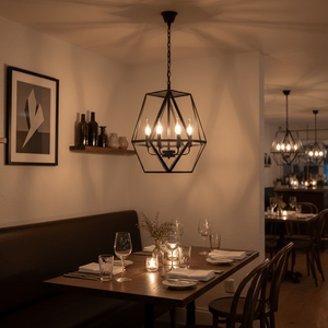 Elegant Maun 4 Light Chandelier hanging above a dining table, casting warm light in a cozy setting.