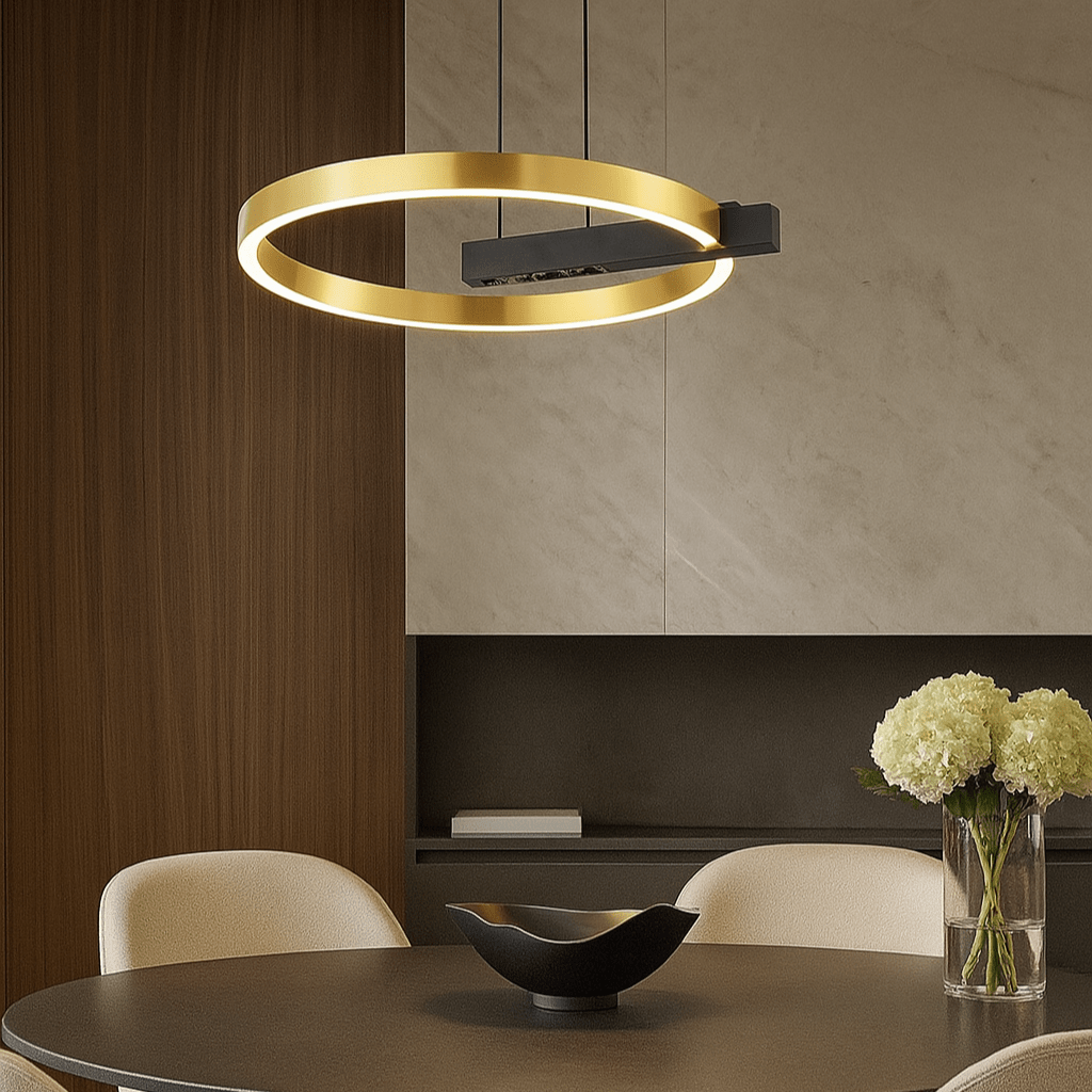 Gold Q LED Pendant Light hanging above a modern dining table with a black bowl and flowers.