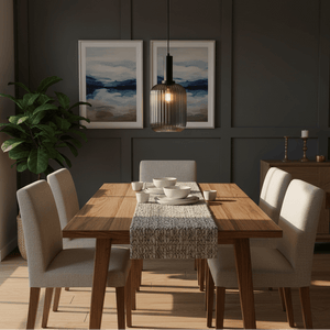 Athina Smoke Cut Glass Pendant hanging over a wooden dining table set with dishes in a modern dining room.