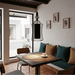 Tokyo 1 Black Wire Frame Pendant light hanging over a wooden table with a coffee cup, surrounded by cozy seating.