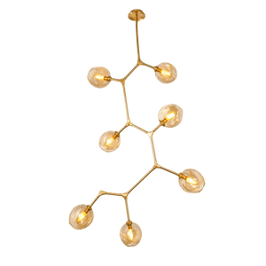 Gold pendant light with seven spherical bulbs arranged in a molecule-like design, suspended from a ceiling mount.