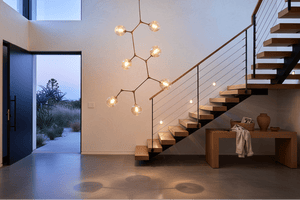 Stylish 7-light molecule pendant light hanging above a wooden table in a modern entrance hall.