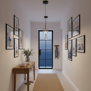 Modern hallway with framed pictures, a console table, and a glass door.