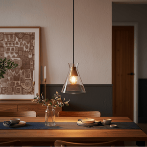 Black & Gold pendant light hanging over a dining table with decorative elements and soft lighting.