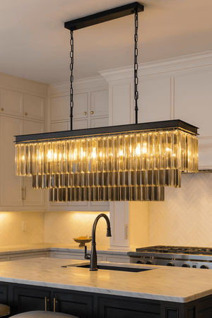 Modern kitchen with a rectangular chandelier hanging above a countertop.