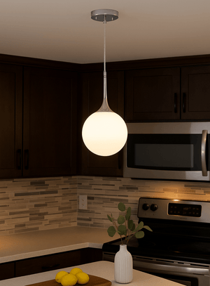 Modern kitchen with pendant light, microwave, and stove.