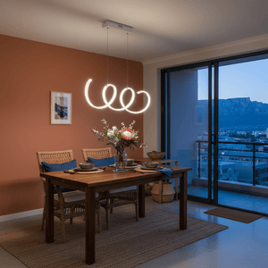 Stylish dining area featuring a modern LED pendant light above a wooden table with floral centerpiece.