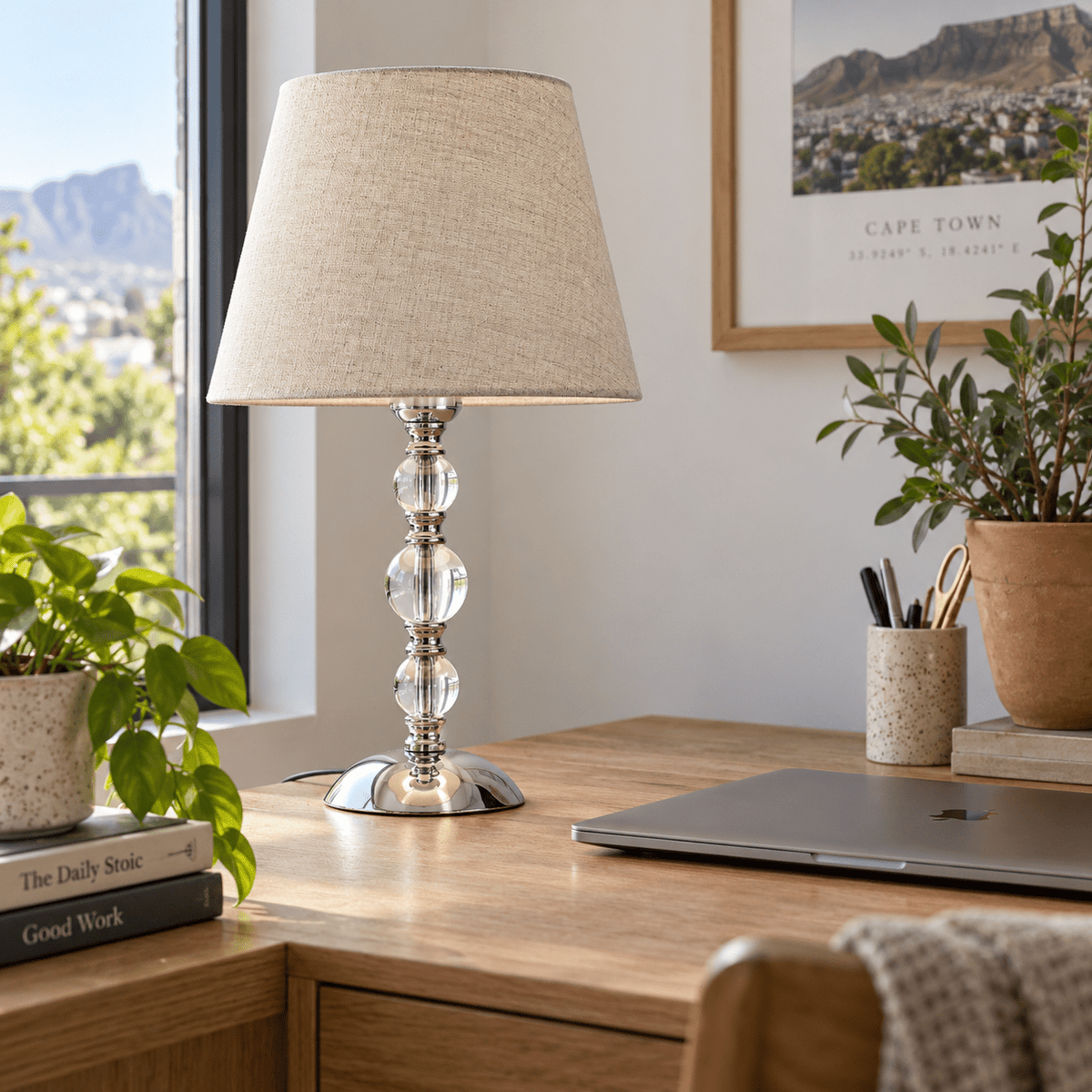Myrna Satin Chrome Table Lamp with Hessian Shade — on a home-office desk in natural daylight