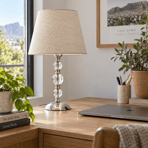 Myrna Satin Chrome Table Lamp with Hessian Shade — on a home-office desk in natural daylight