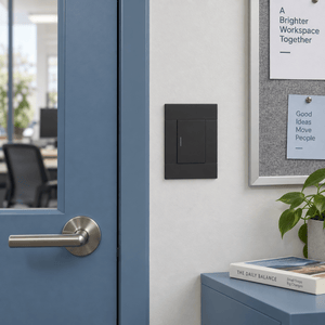 Veti 2 Charcoal Single Lever Wall Switch in a realistic dusty-blue office corridor setting