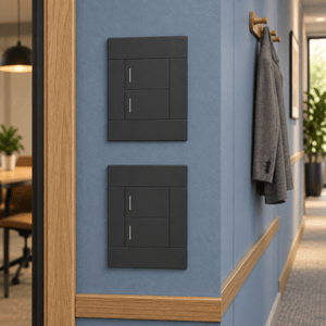 Veti 2 Charcoal Two Lever Wall Switch in a realistic dusty-blue office corridor setting