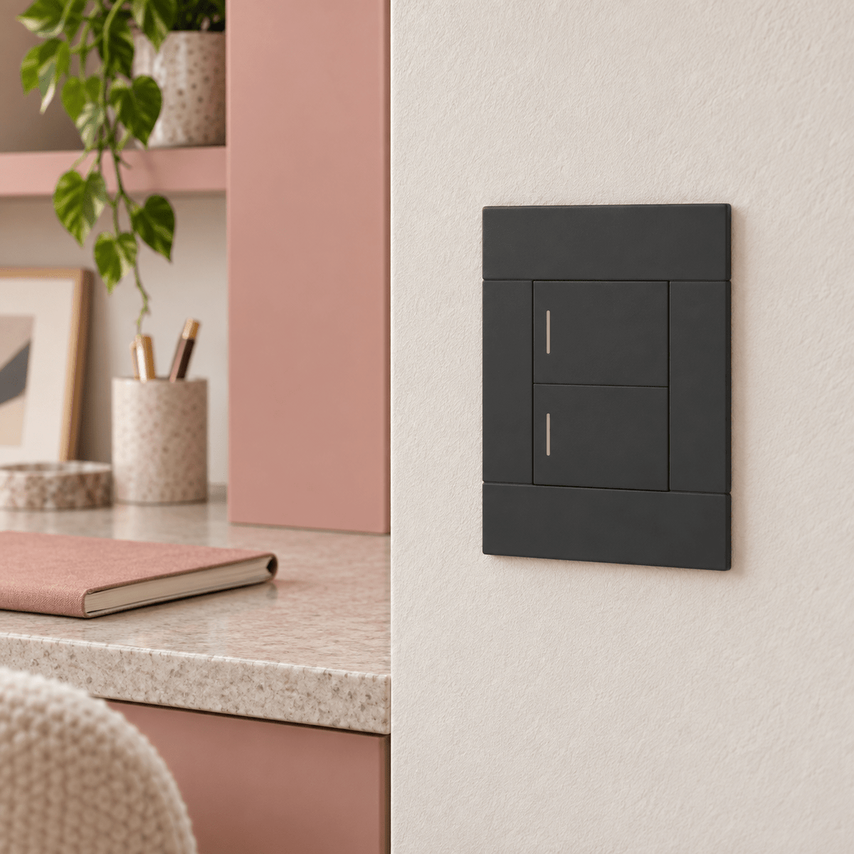Veti 2 Charcoal Two Lever Wall Switch in a realistic clay-pink desk area setting