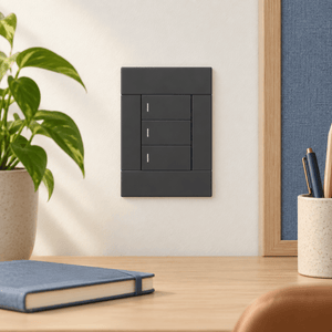 Veti 2 Charcoal Three Lever Wall Switch in a realistic home office setting