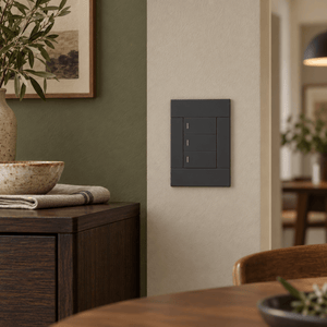 Veti 2 Charcoal Three Lever Wall Switch in a realistic dining room setting