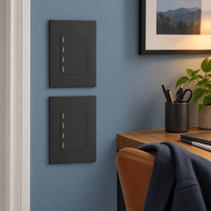 Veti 2 Charcoal Four Lever Wall Switch in a realistic dusty-blue office setting