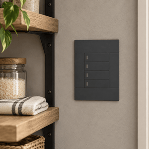 Veti 2 Charcoal Four Lever Wall Switch in a realistic warm-grey pantry setting