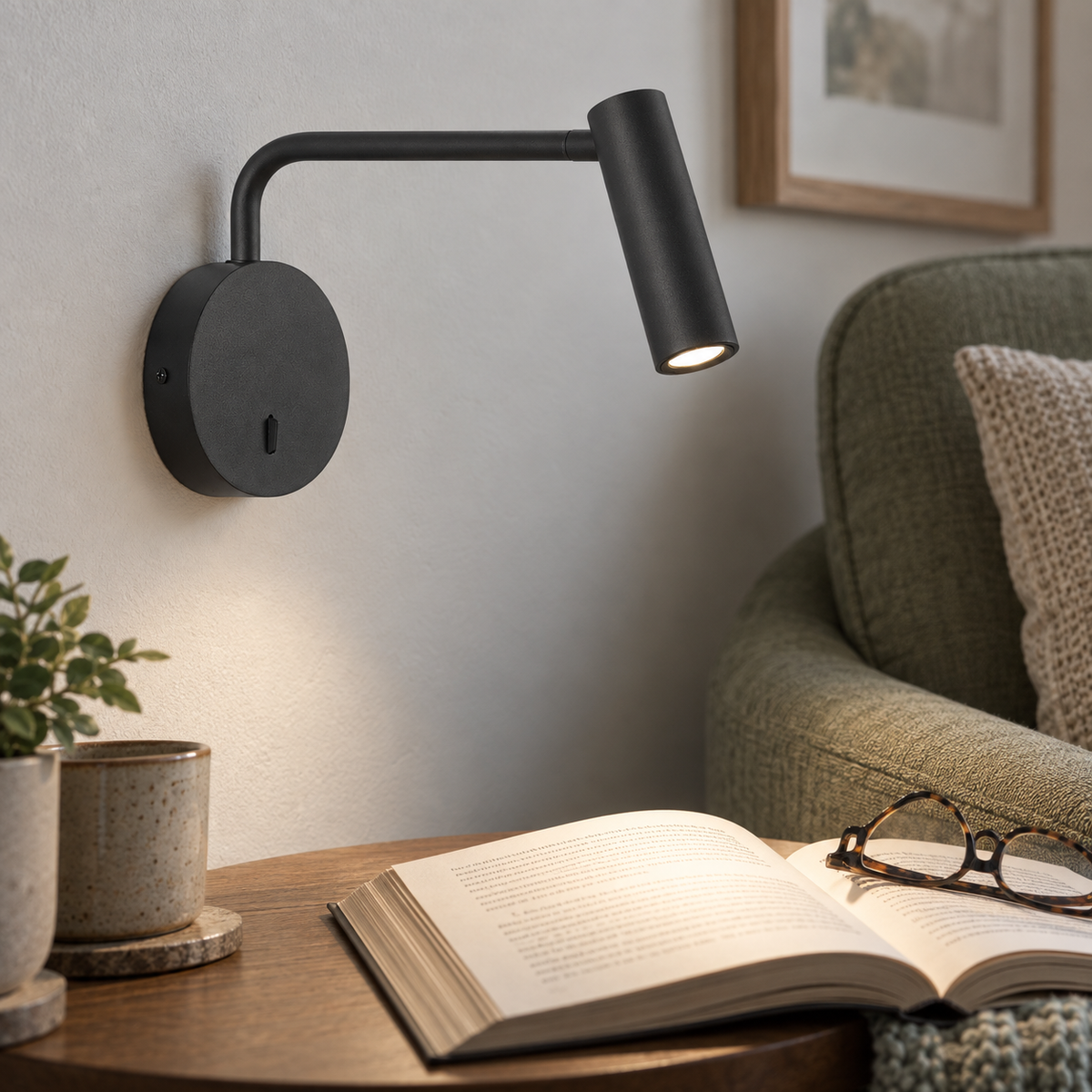 Minine Sand Black LED Wall Light lifestyle: Close detail view of the wall light head aiming at a reading surface