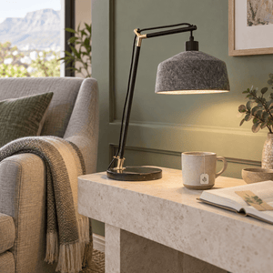 Moonwalker Marble & Felt Table Lamp lifestyle image: Reading corner on a pale limestone console table