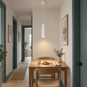 Pinkie White Flute Pendant Light lifestyle: Longer view in a hallway dining nook: pendant over small table