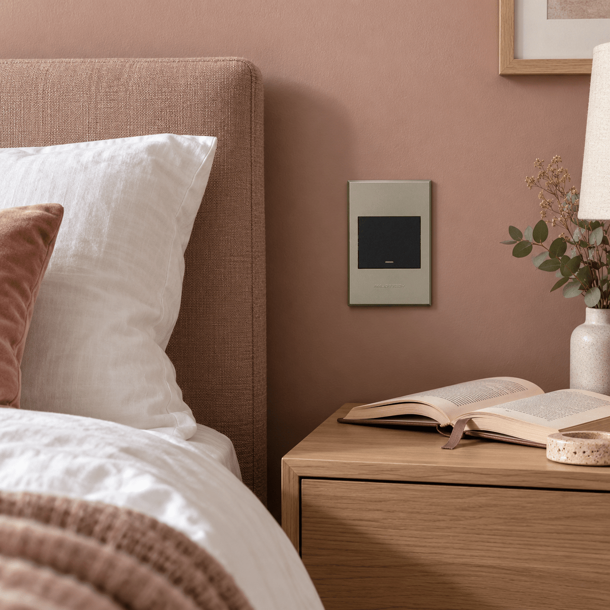 Veti 3 - One Lever, Two Way Light Switch - Graphite / Titanium lifestyle image: Bedroom bedside control, cabinet and muted clay-pink wall