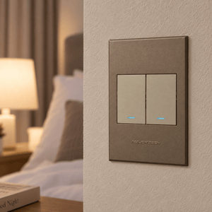 Veti 3 - Two Lever, One Way Light Switch - Titanium / Bronze lifestyle: Bedroom close-up of the flush switch face with locator glow