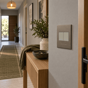 Veti 3 - Two Lever, One Way Light Switch - Titanium / Bronze lifestyle: Hallway near entry console with warm natural daylight and locator glow
