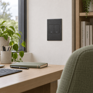 Veti 3 - Two Lever - 1 x Bell Press & 1 x Two Way Light Switch - Graphite / Graphite lifestyle image: Graphite switch beside a home office desk