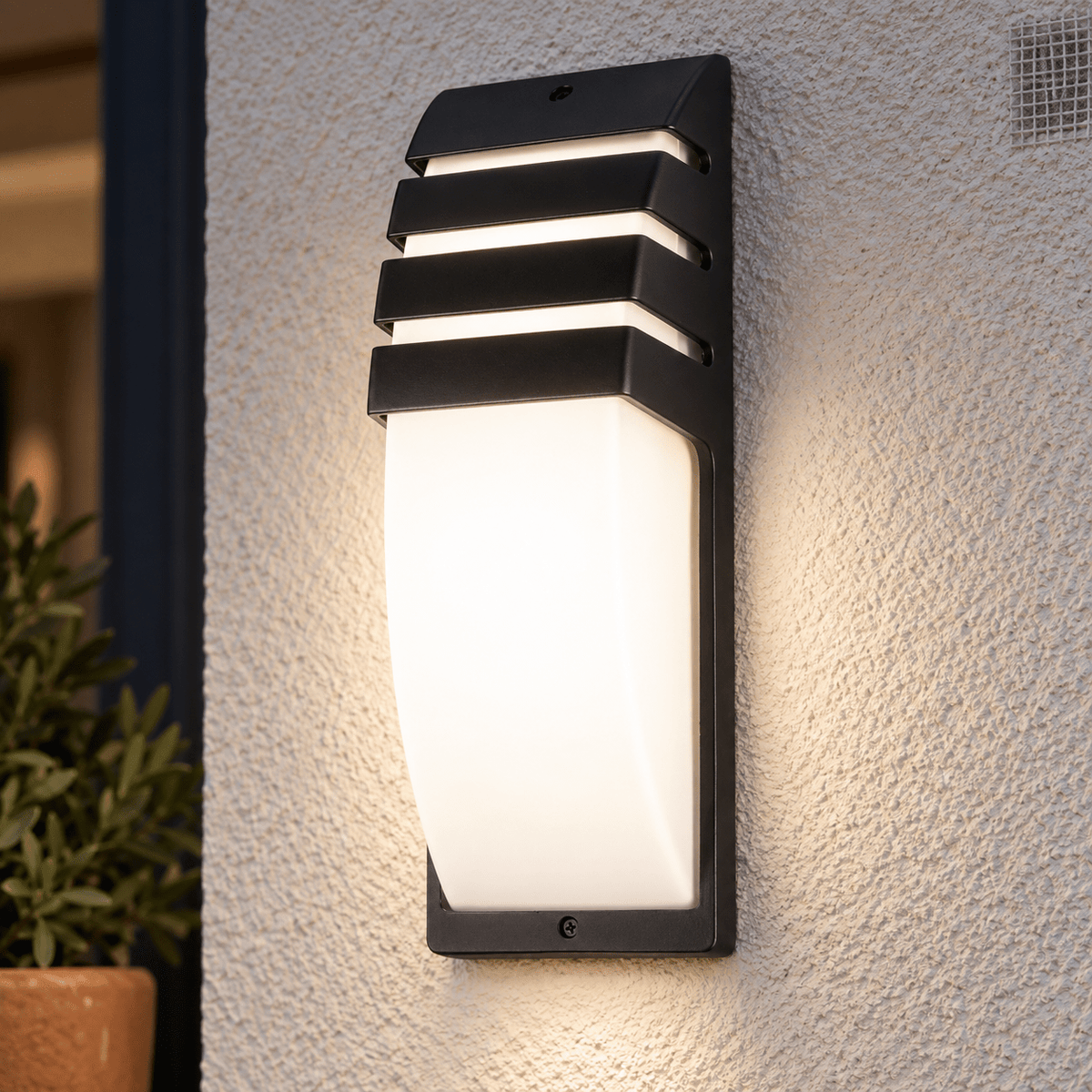 Aurora Outdoor Wall Light lifestyle image: Close detail of the lamp front cover and wall contact