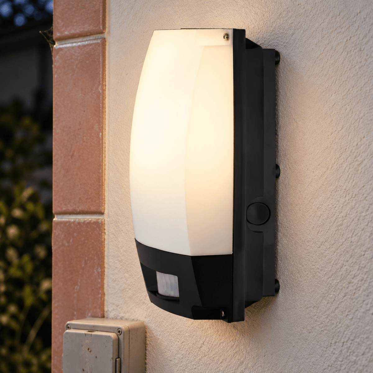 Outdoor Wall Mount Motion Sensor Bulkhead lifestyle image: Close-up detail of the opal lens and motion sensor on the exterior wall