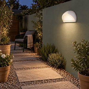 White Aluminium Wall Light with Frosted Glass IP54 lifestyle image: Boundary wall accent along a garden path