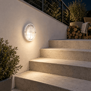 Round PVC Grid Bulkhead - Clear Glass IP44 - White lifestyle image: Patio wall beside a short stair run