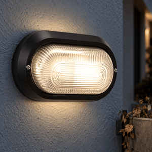 Outdoor Wall Light Gabriel Black PVC with Clear Glass — PROMPT 3 — Close-Up Reading the Clear Glass and Bulkhead Edges